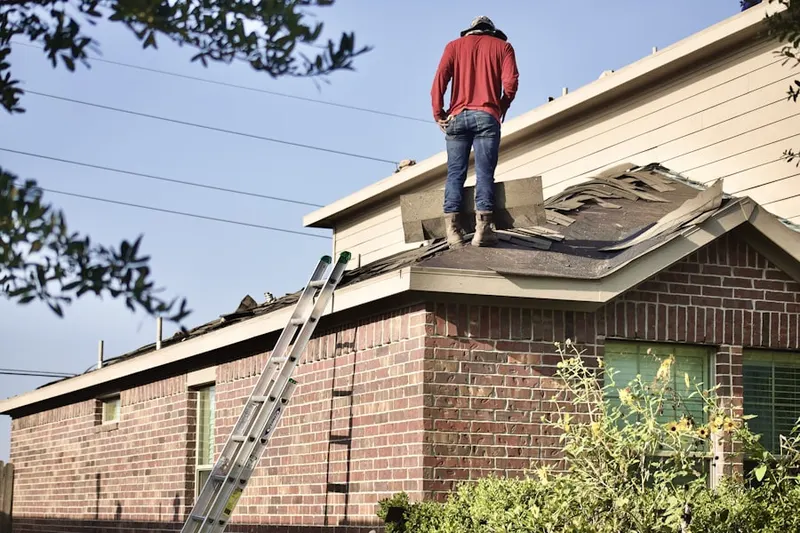 Professional roofer working on a residential roof in Buck Landing
